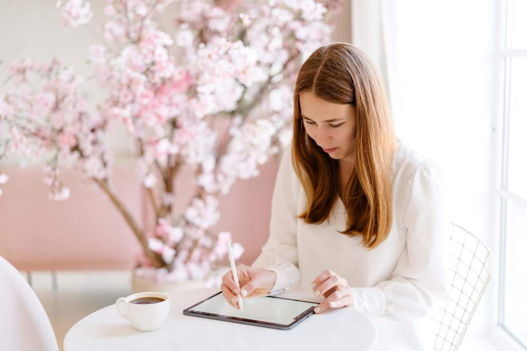 A close-up image of a woman journaling with a pen. The alt text reads: "Weekly reflection questions: Discover the ultimate guide to 25 thought-provoking questions for personal introspection and growth