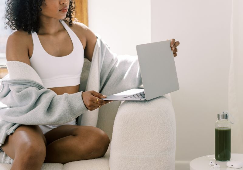 a young woman setting goals with her laptop in her hand, wearing fitness fit as a featured image for part of life to set goals