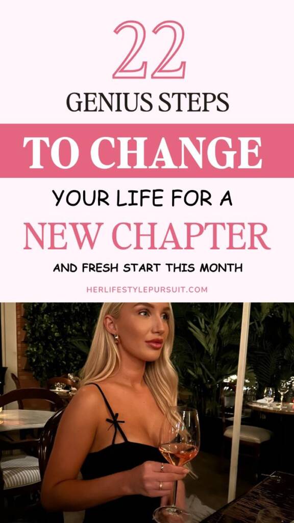 A soft pink and white graphic with bold text that reads: "22 Genius Steps to Change Your Life for a New Chapter and Fresh Start This Month." The bottom half features a stylish blonde woman in a black dress, seated at a restaurant with a glass of rosé wine in hand. The setting is cozy and elegant, with lush greenery in the background. Website: herlifestylepursuit.com