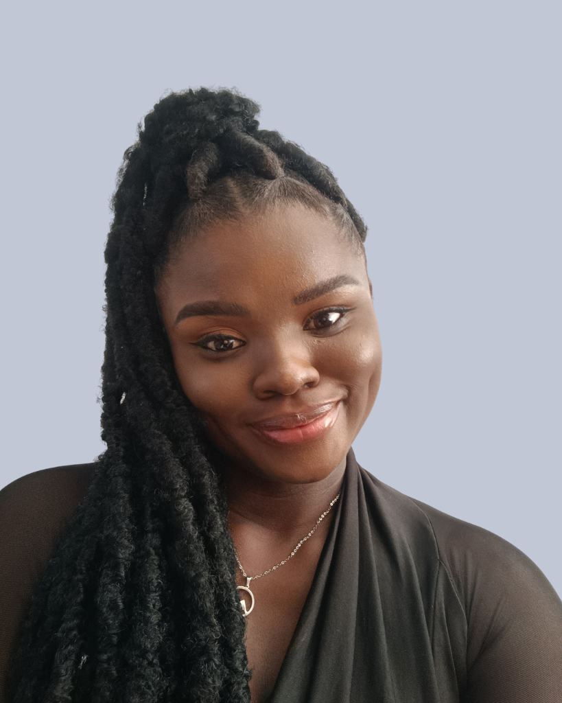Faith Ola, founder of Her Lifestyle Pursuit, smiling confidently in a black outfit with long braided hair styled in a high ponytail against a soft neutral background — representing calm, confidence, and intentional living.